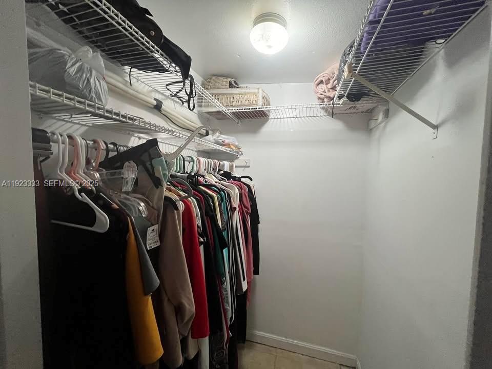 24 Ave Fort, Unit C Fort Lauderdale, FL 33312 - Photo 4 of 4 a view of walk in closet with clothes and shoes