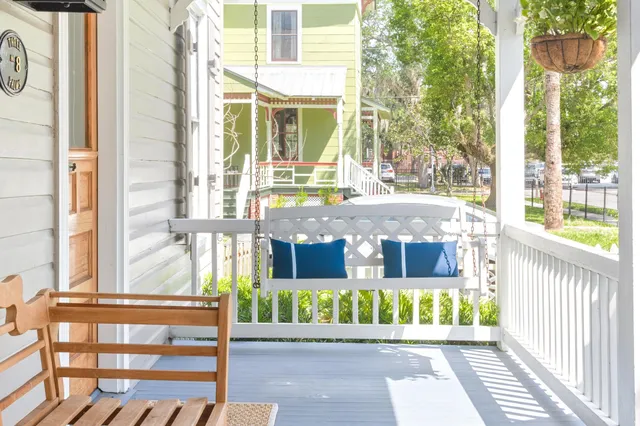 a kitchen with stainless steel appliances granite countertop a sink a stove a dining table and chairs
