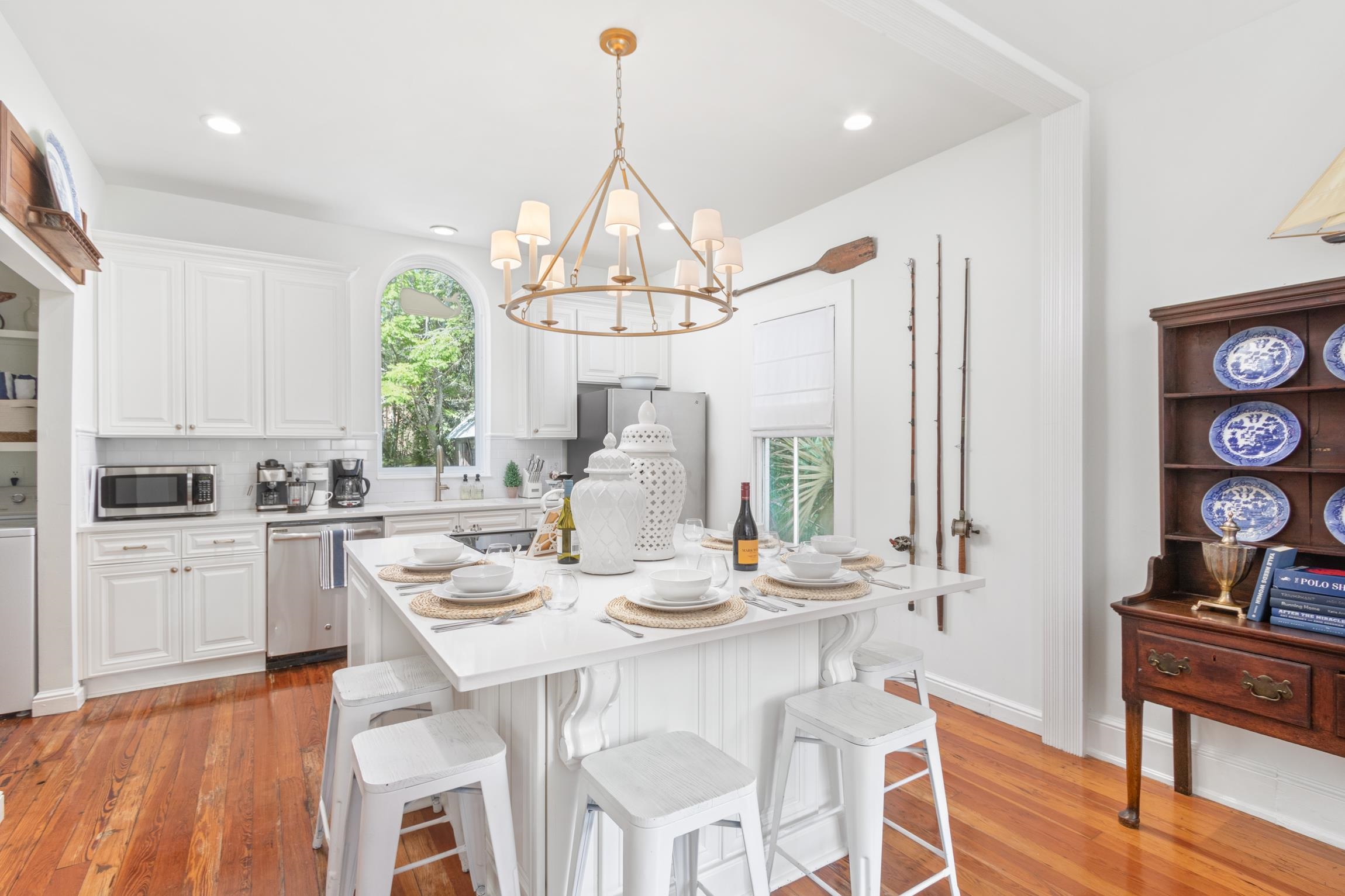 8 Sevilla Street St. Augustine, FL 32084 - Photo 13 of 73 a kitchen with stainless steel appliances kitchen island granite countertop a stove a sink dishwasher and white cabinets with wooden floor