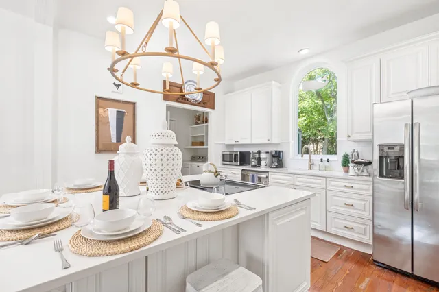 a living room with furniture wooden floor and a large window