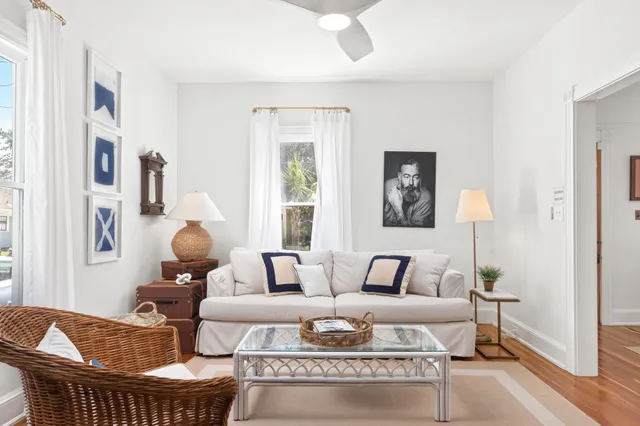 a living room with furniture a fireplace and a large window