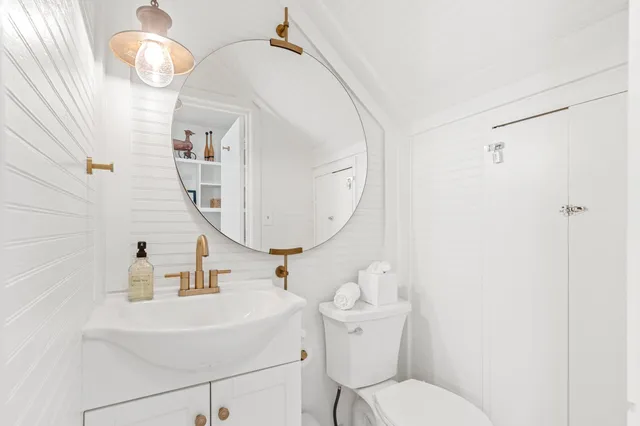 a bathroom with a sink mirror and vanity