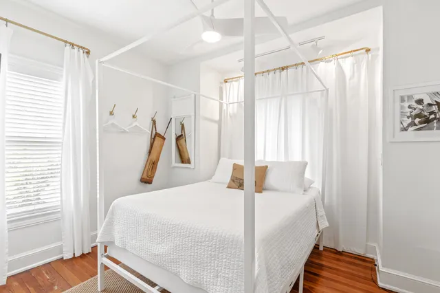 a bedroom with a bed flat screen tv and a window