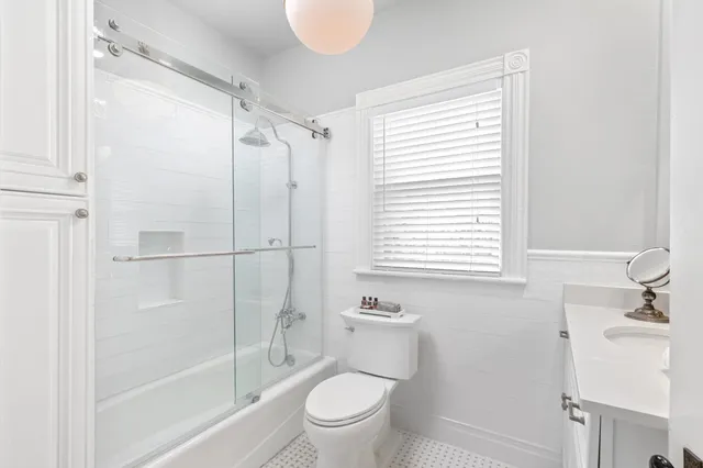 a bedroom with a bed window and walk in closet