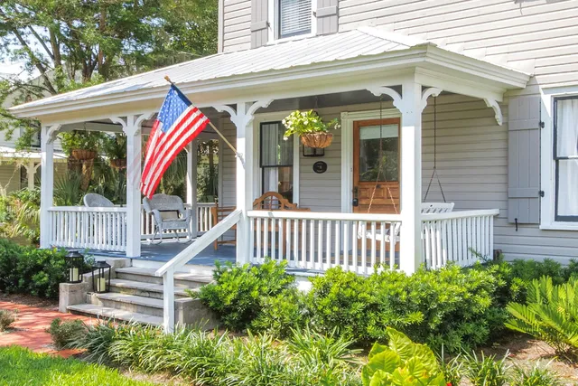 a view of a patio with a table chairs and a glass door