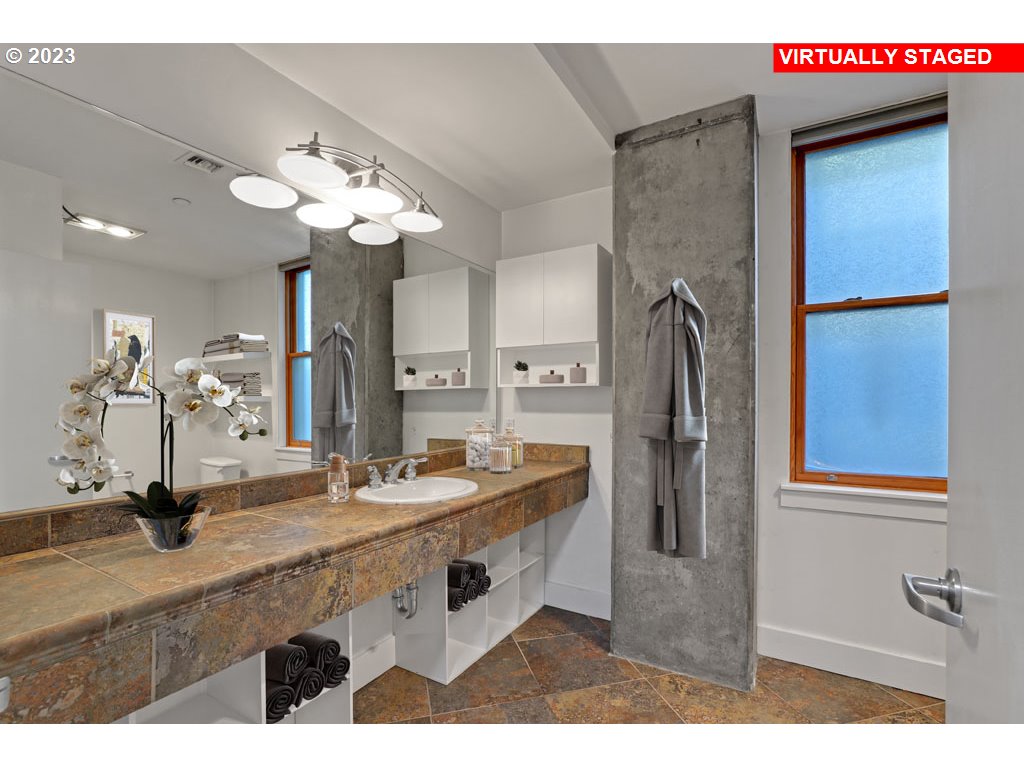 411 Northwest Flanders Street, Unit 401 Portland, OR 97209 - Photo 15 of 38 a bathroom with a sink double vanity and a mirror