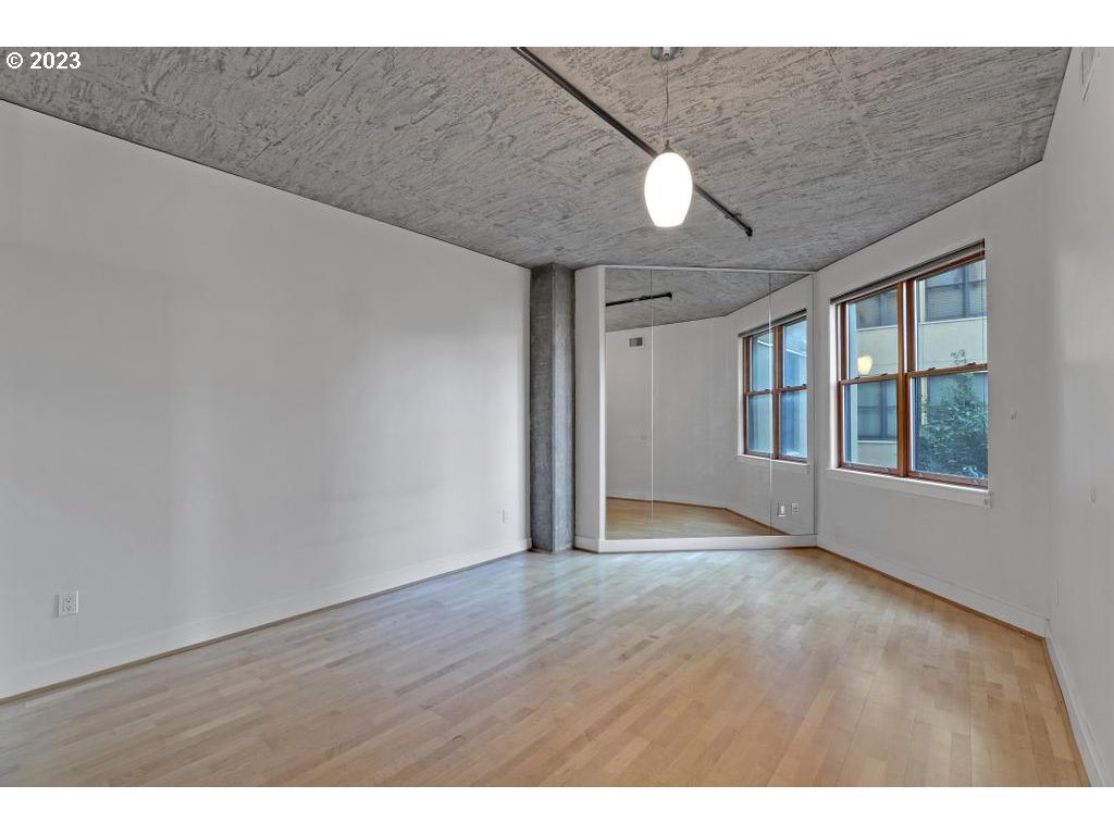 411 Northwest Flanders Street, Unit 401 Portland, OR 97209 - Photo 17 of 38 a view of an empty room with a window