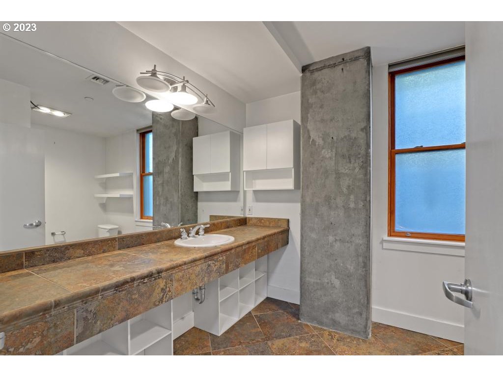 411 Northwest Flanders Street, Unit 401 Portland, OR 97209 - Photo 24 of 38 a bathroom with a sink and a mirror