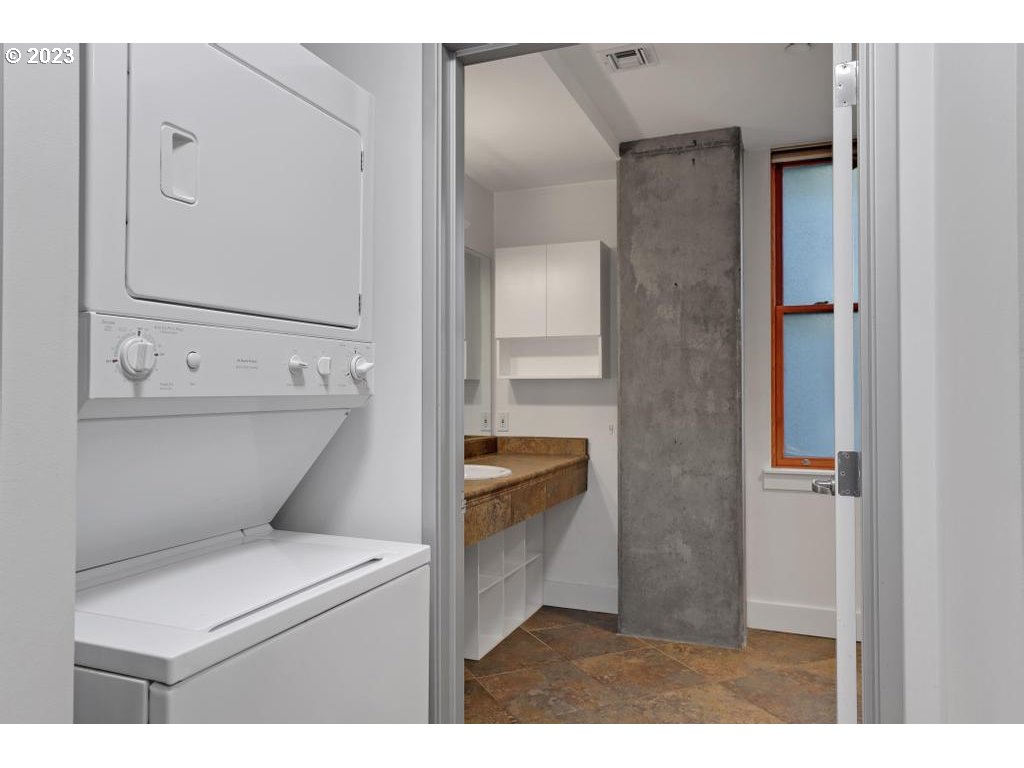 411 Northwest Flanders Street, Unit 401 Portland, OR 97209 - Photo 26 of 38 a bathroom with a toilet sink and mirror
