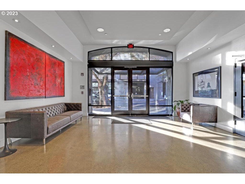 411 Northwest Flanders Street, Unit 401 Portland, OR 97209 - Photo 3 of 38 a living room with furniture and a large window
