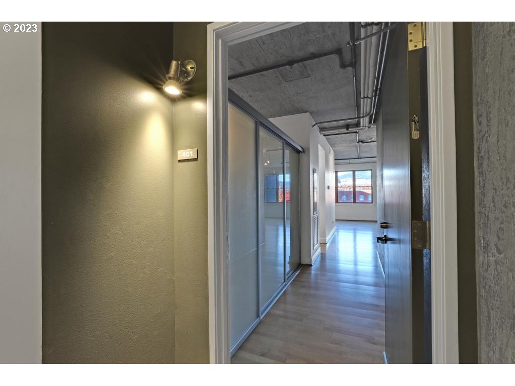 411 Northwest Flanders Street, Unit 401 Portland, OR 97209 - Photo 6 of 38 a view of hallway with stairs and wooden floor