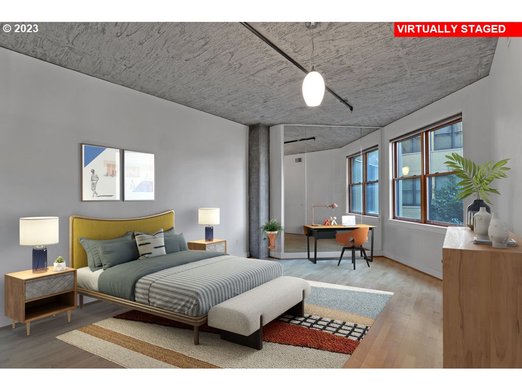 411 Northwest Flanders Street, Unit 401 Portland, OR 97209 - Photo 8 of 38 a bedroom with a large bed and a couch