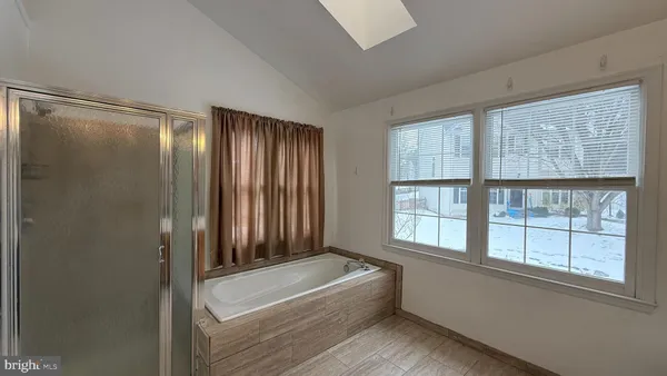 a bathroom with a bathtub and a shower