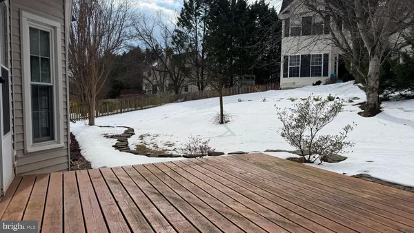 a view of a backyard with wooden fence