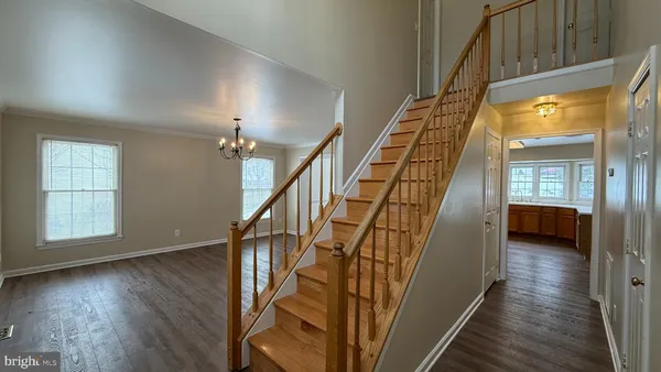 a view of entryway and hall with wooden floor