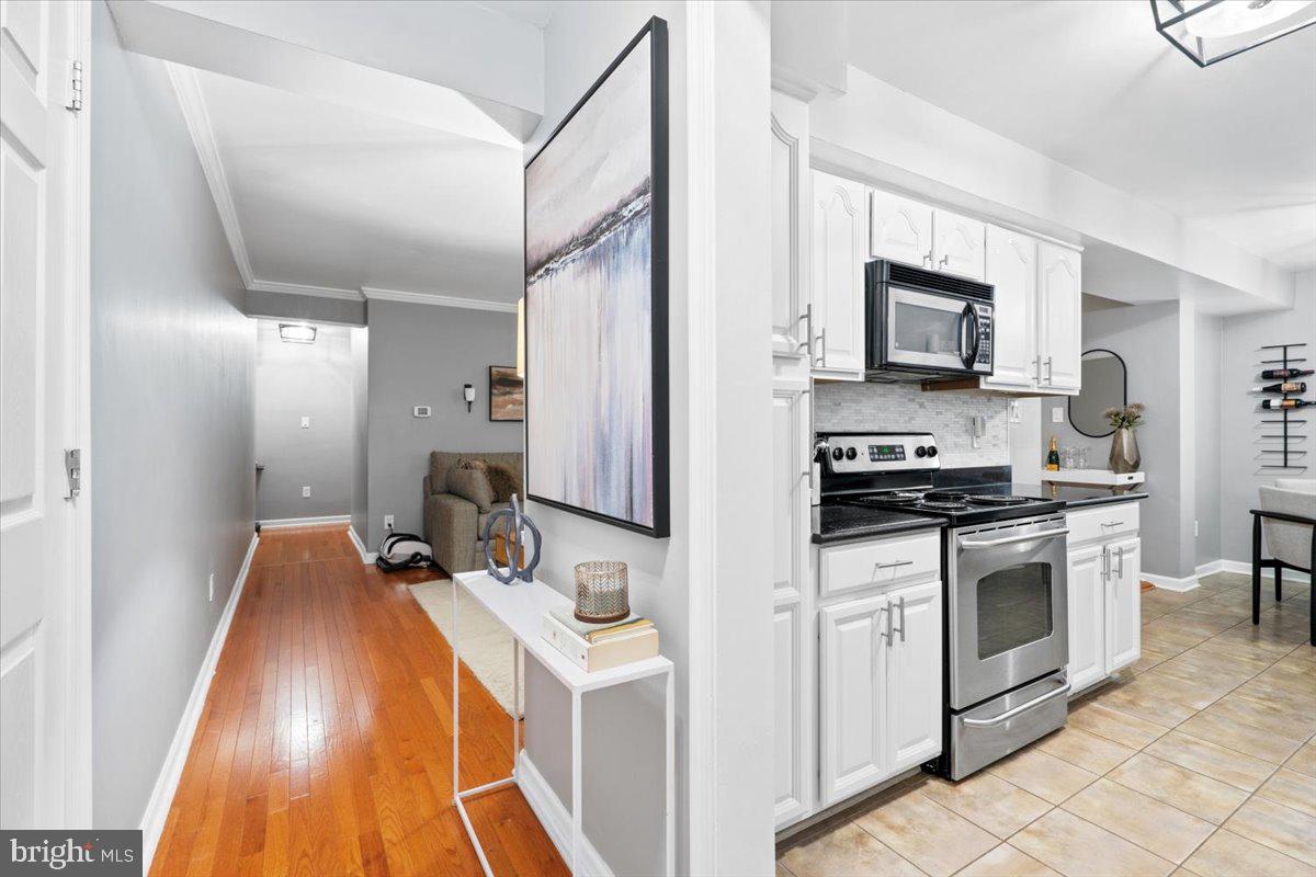 3332 Spring Lane, Unit C10 Falls Church, VA 22041 - Photo 14 of 25 a kitchen with stainless steel appliances a stove microwave and sink