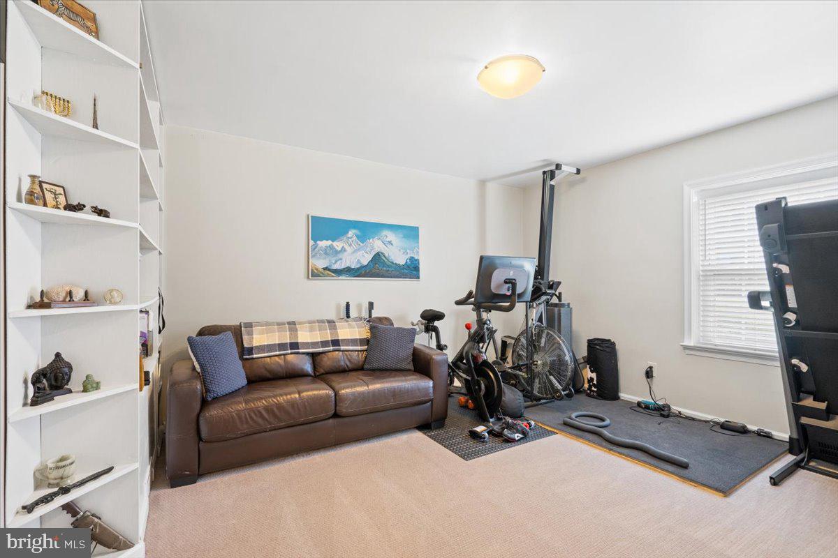 3332 Spring Lane, Unit C10 Falls Church, VA 22041 - Photo 17 of 25 a living room with furniture a window and gym equipment