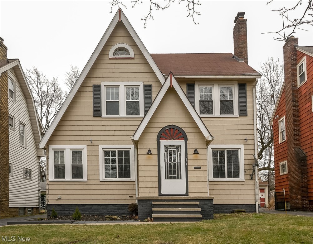 English style home featuring a front yard