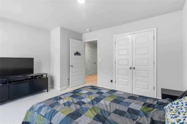 a bedroom with a bed and flat screen tv