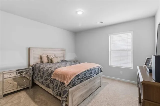 a bedroom with a bed and chair