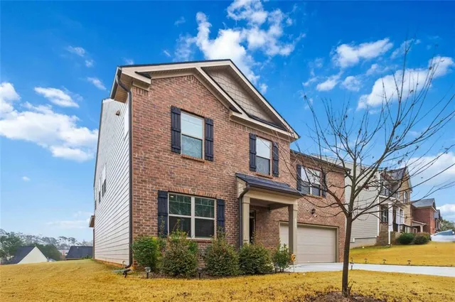 a front view of a house with a yard