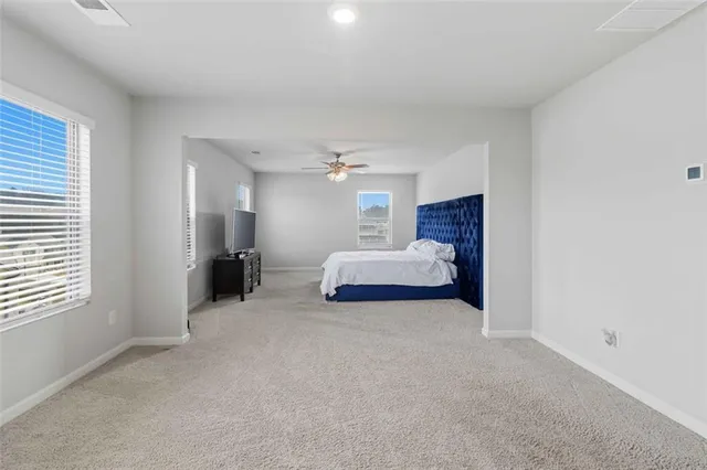 a bed room with a bed and a window