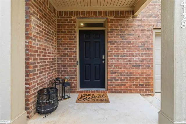 a view of a door and brick wall