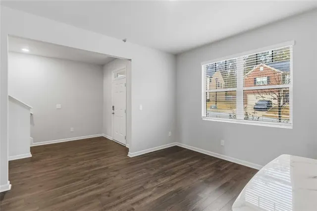 a view of a livingroom with wooden floor and a window