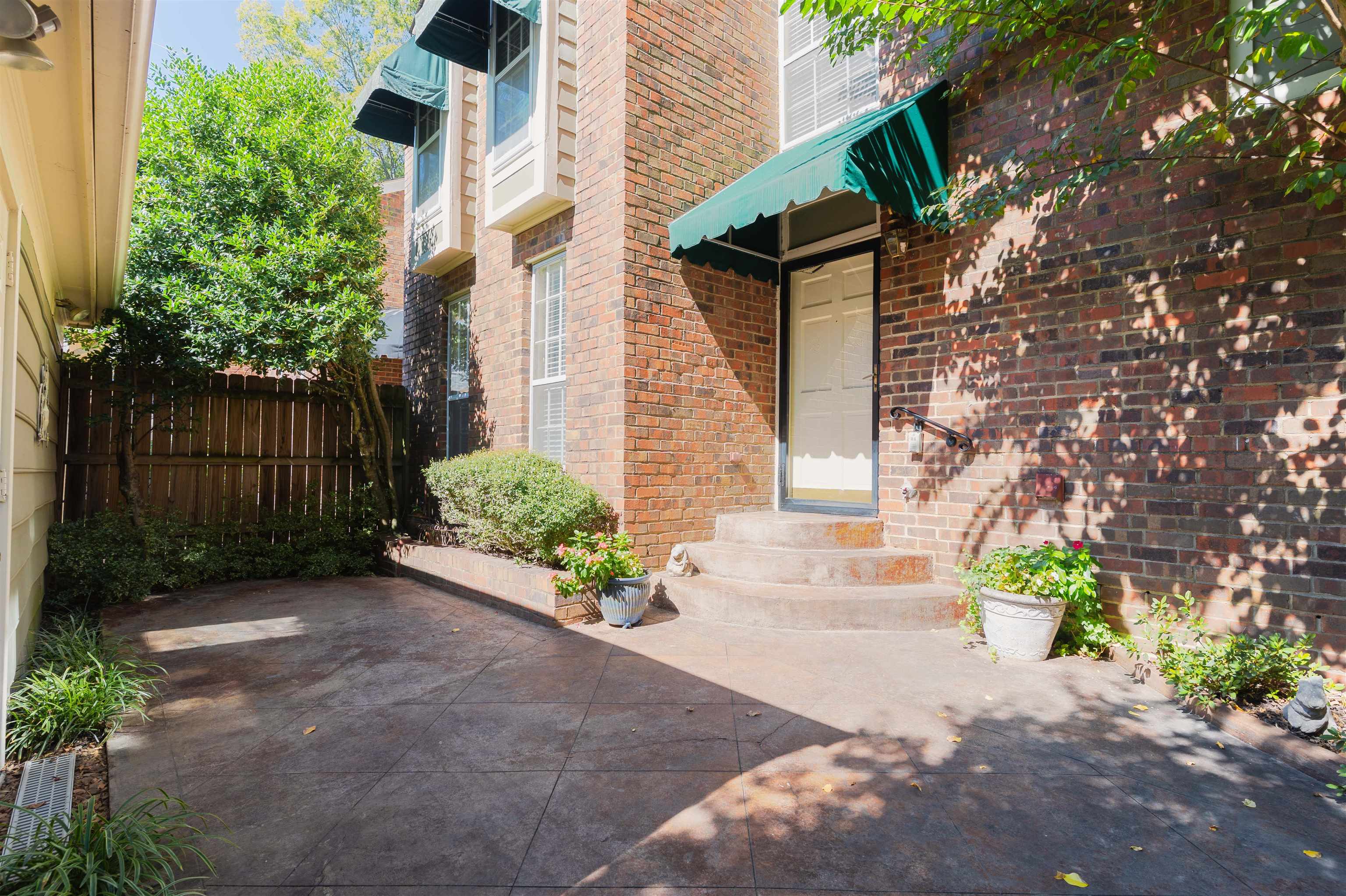 a front view of a house with a yard and a garden