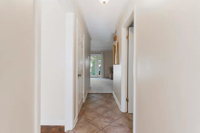 a view of a hallway with wooden shelves
