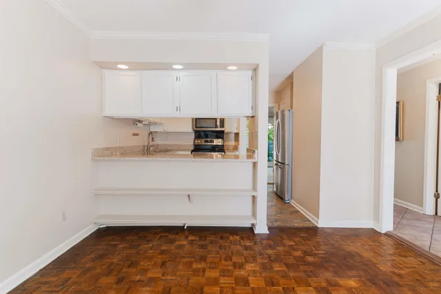 a kitchen with a sink stainless steel appliances and cabinets
