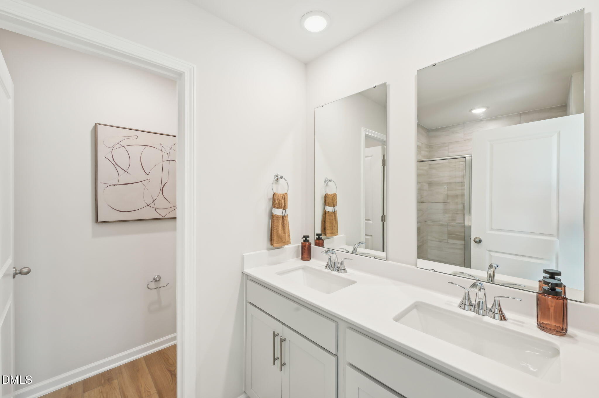 924 Broadleaf Trace Mebane, NC 27302 - Photo 16 of 26 a bathroom with a double vanity sink and a mirror