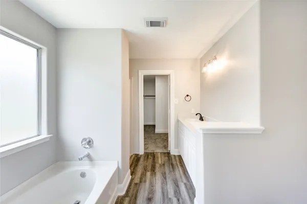 a bathroom with a bathtub and a sink
