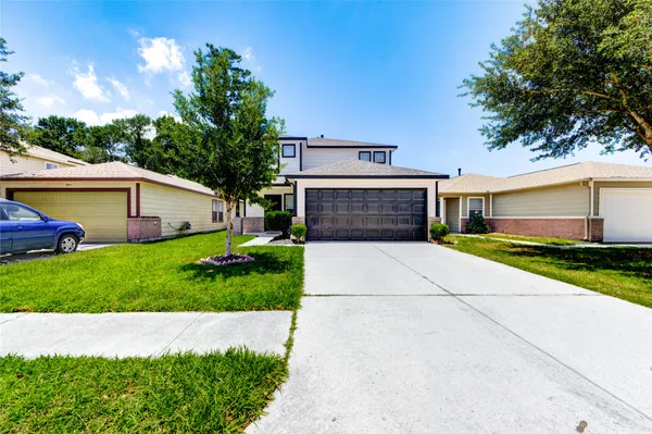 a front view of a house with a yard and garage