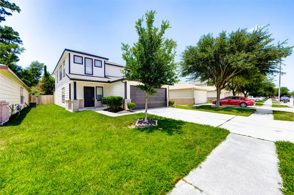 a front view of a house with a yard and garage