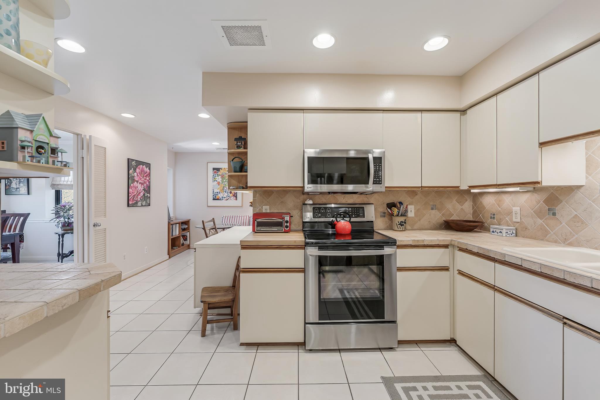 11500 Fairway Drive, Unit 507 Reston, VA 20190 - Photo 16 of 41 a kitchen with a sink a counter top space appliances and cabinets