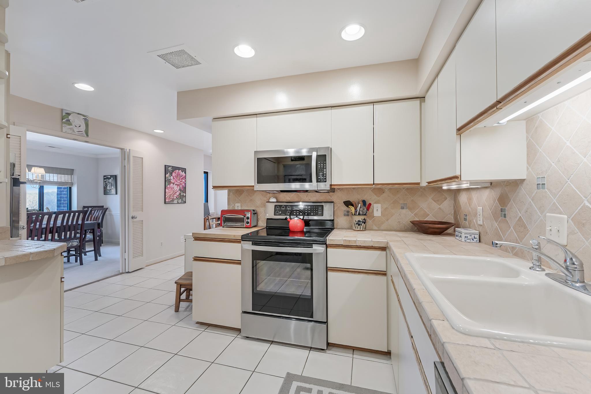 11500 Fairway Drive, Unit 507 Reston, VA 20190 - Photo 17 of 41 a kitchen with a sink and white cabinets