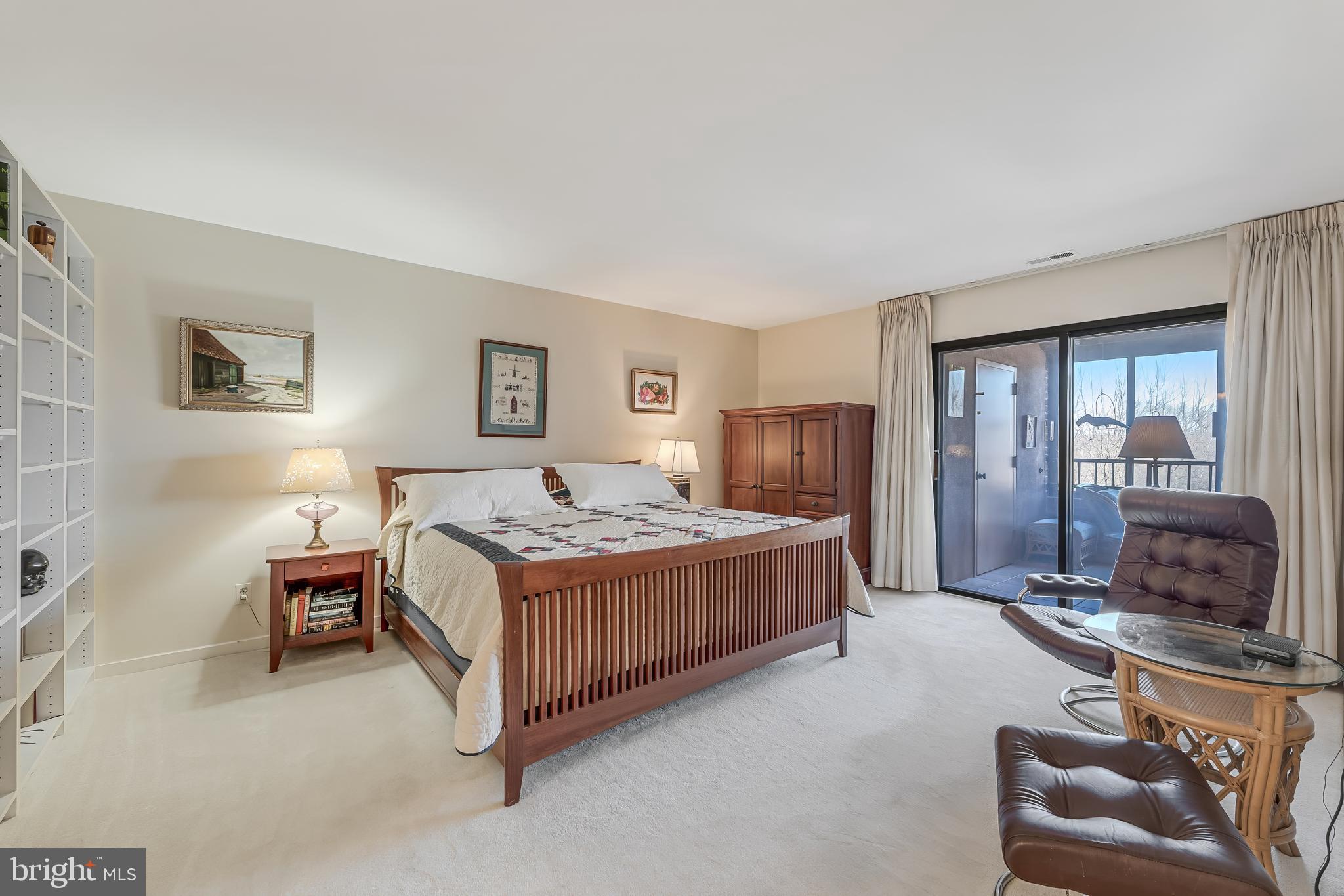 11500 Fairway Drive, Unit 507 Reston, VA 20190 - Photo 24 of 41 a bedroom with a bed and glass window