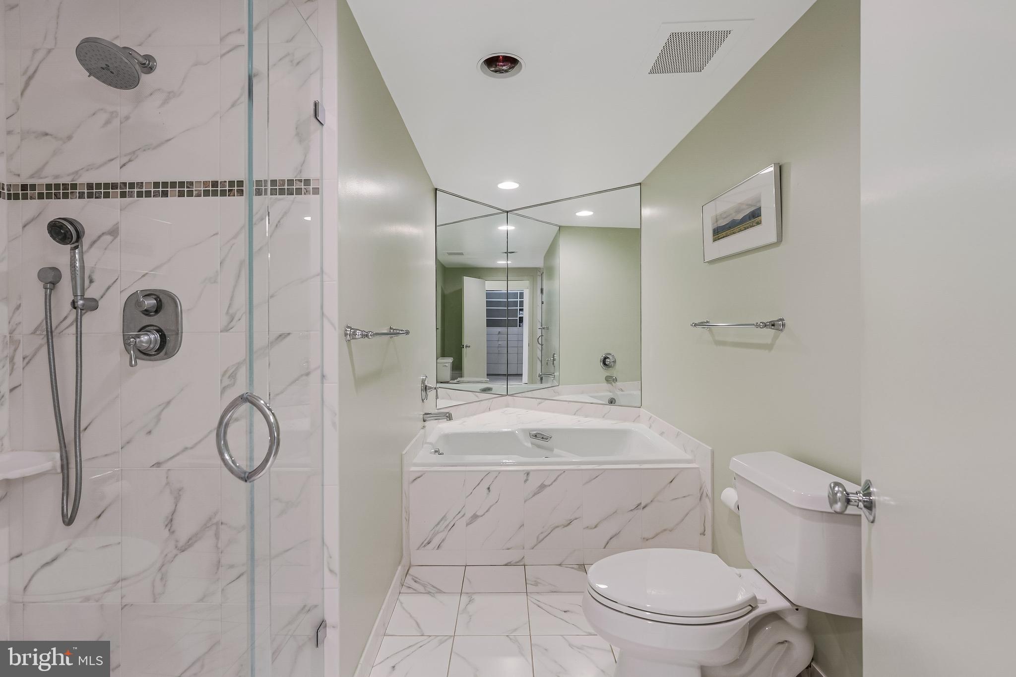 11500 Fairway Drive, Unit 507 Reston, VA 20190 - Photo 27 of 41 a bathroom with a granite countertop sink a toilet and shower