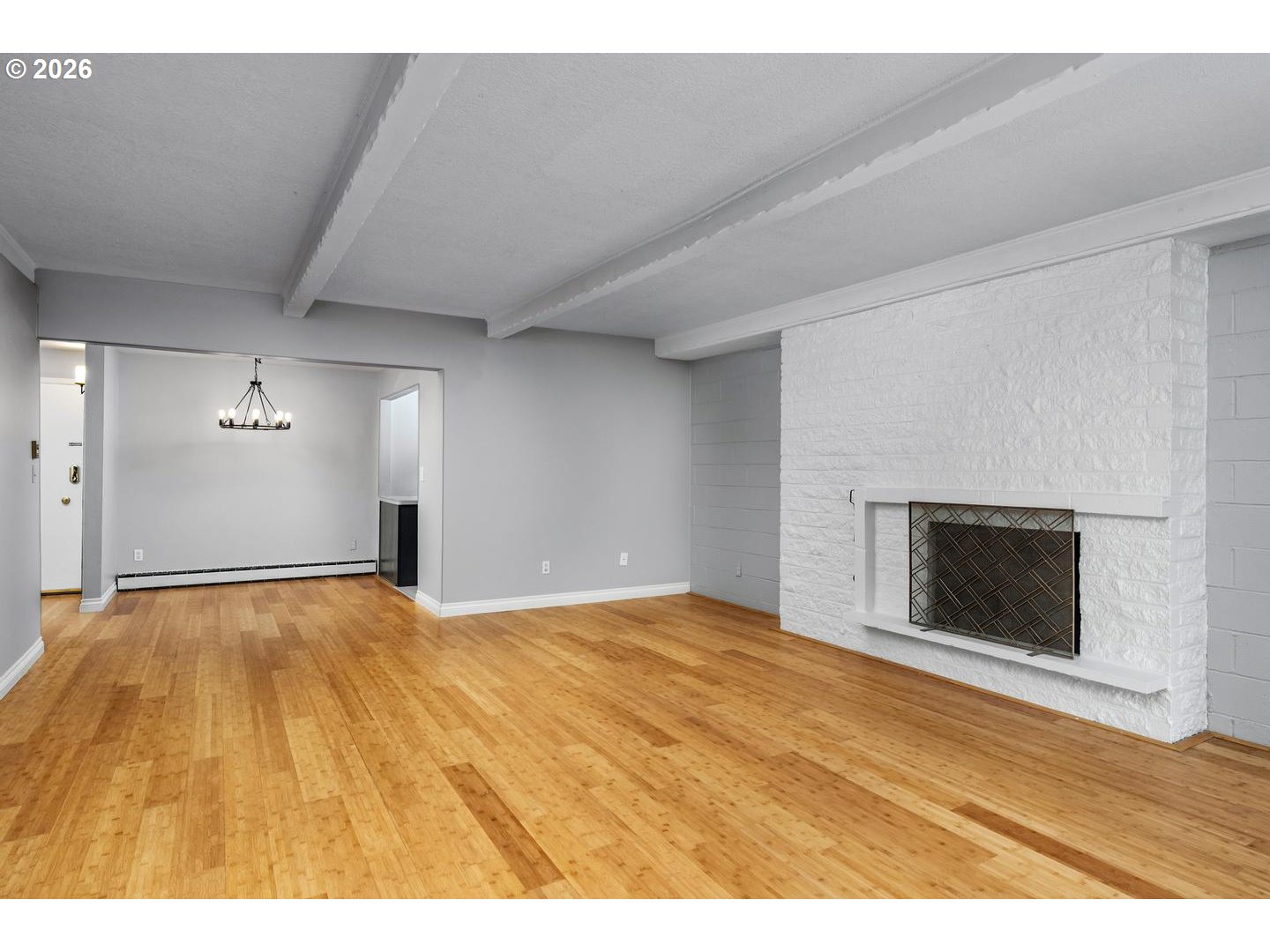 4460 Southwest Scholls Ferry Road, Unit 8 Portland, OR 97225 - Photo 11 of 31 a view of an empty room with wooden floor fireplace and a window