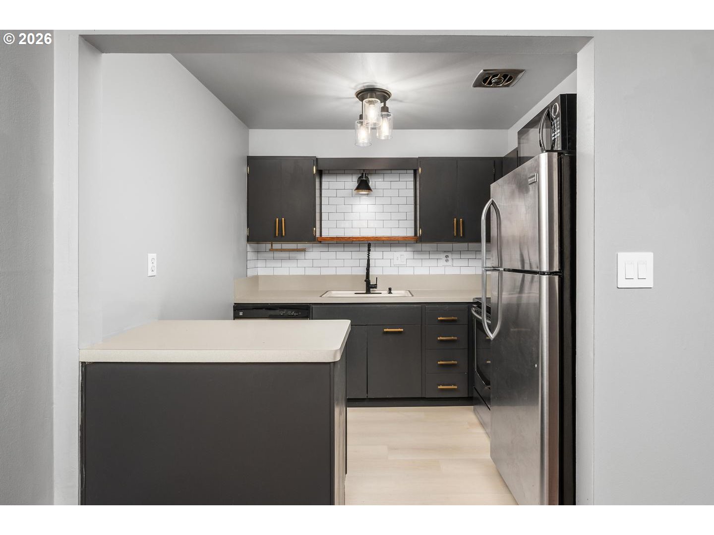 4460 Southwest Scholls Ferry Road, Unit 8 Portland, OR 97225 - Photo 14 of 31 a kitchen with stainless steel appliances granite countertop a sink refrigerator and microwave