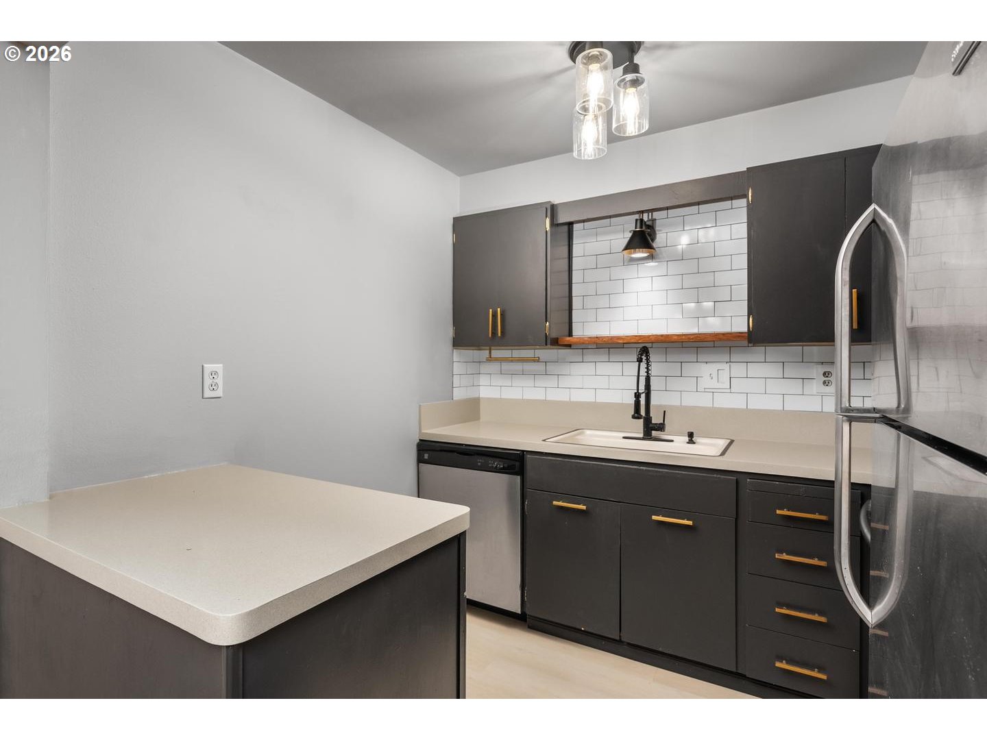 4460 Southwest Scholls Ferry Road, Unit 8 Portland, OR 97225 - Photo 15 of 31 a kitchen with a sink and a refrigerator