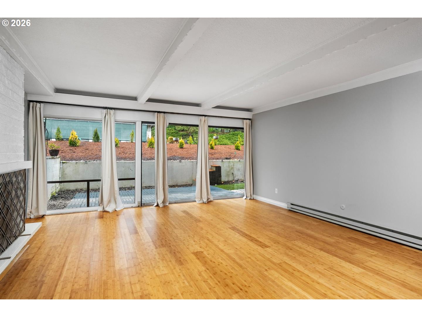4460 Southwest Scholls Ferry Road, Unit 8 Portland, OR 97225 - Photo 5 of 31 a view of an empty room with wooden floor and a window
