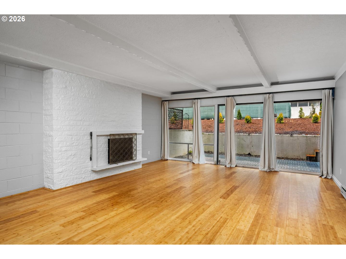 4460 Southwest Scholls Ferry Road, Unit 8 Portland, OR 97225 - Photo 8 of 31 a view of an empty room with a fireplace and a window