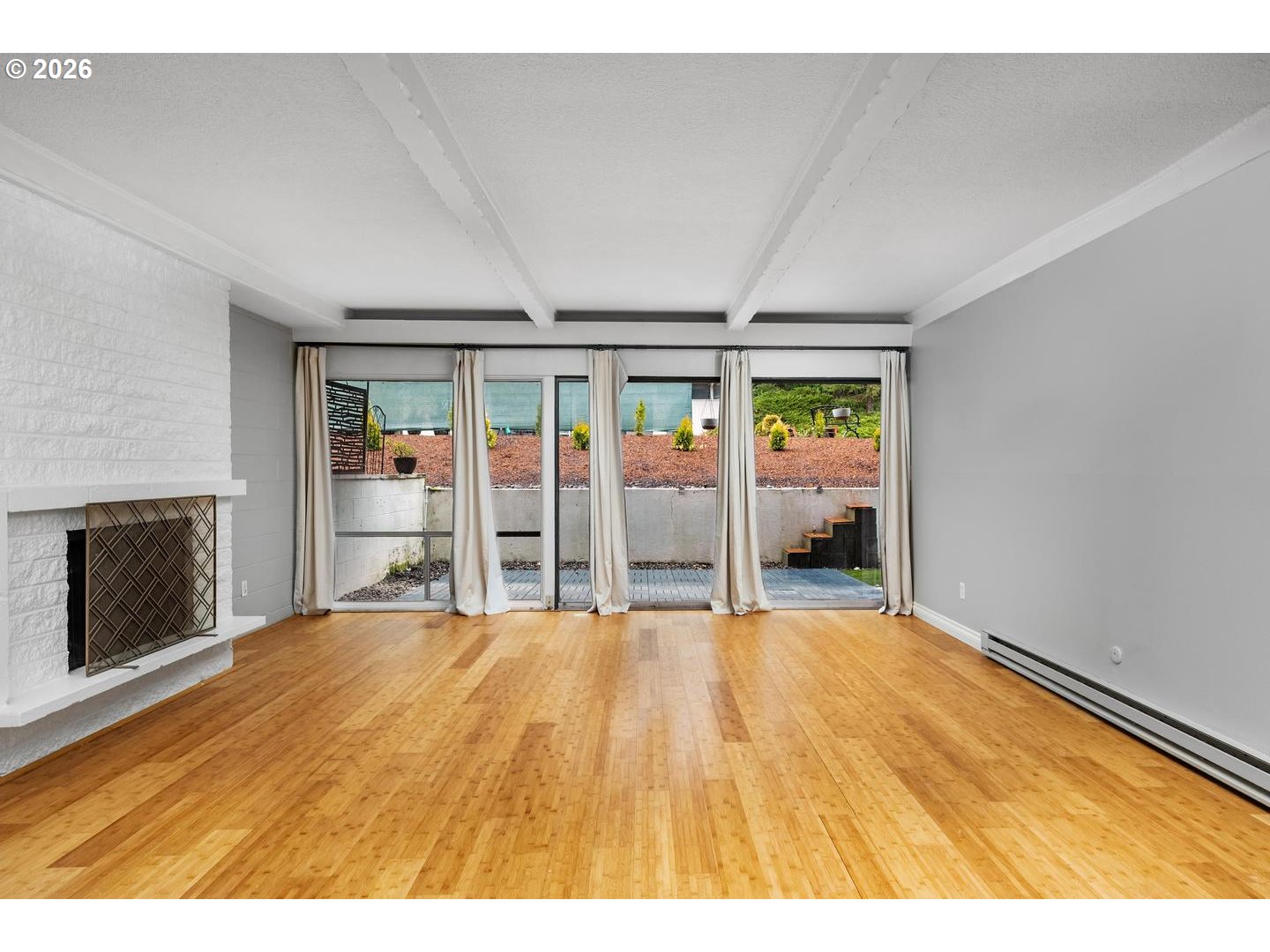 4460 Southwest Scholls Ferry Road, Unit 8 Portland, OR 97225 - Photo 9 of 31 a view of an empty room with a fireplace and a window