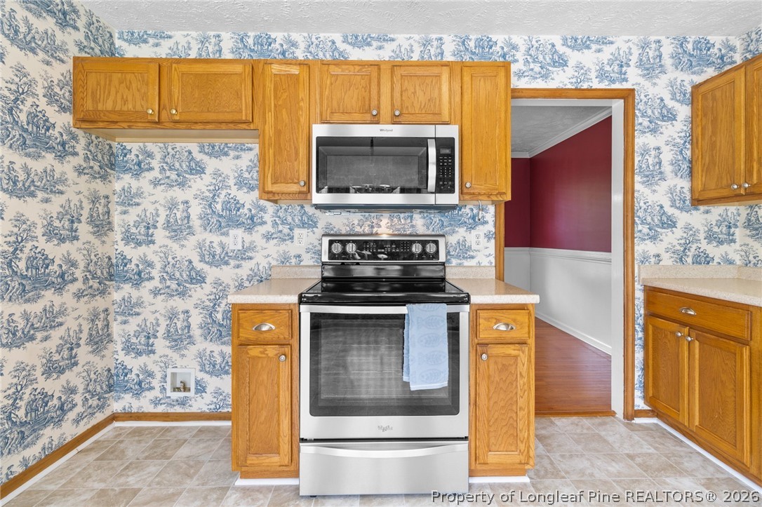 28 Coyt Circle Spring Lake, NC 28390 - Photo 15 of 41 a kitchen with stainless steel appliances granite countertop a stove and a microwave