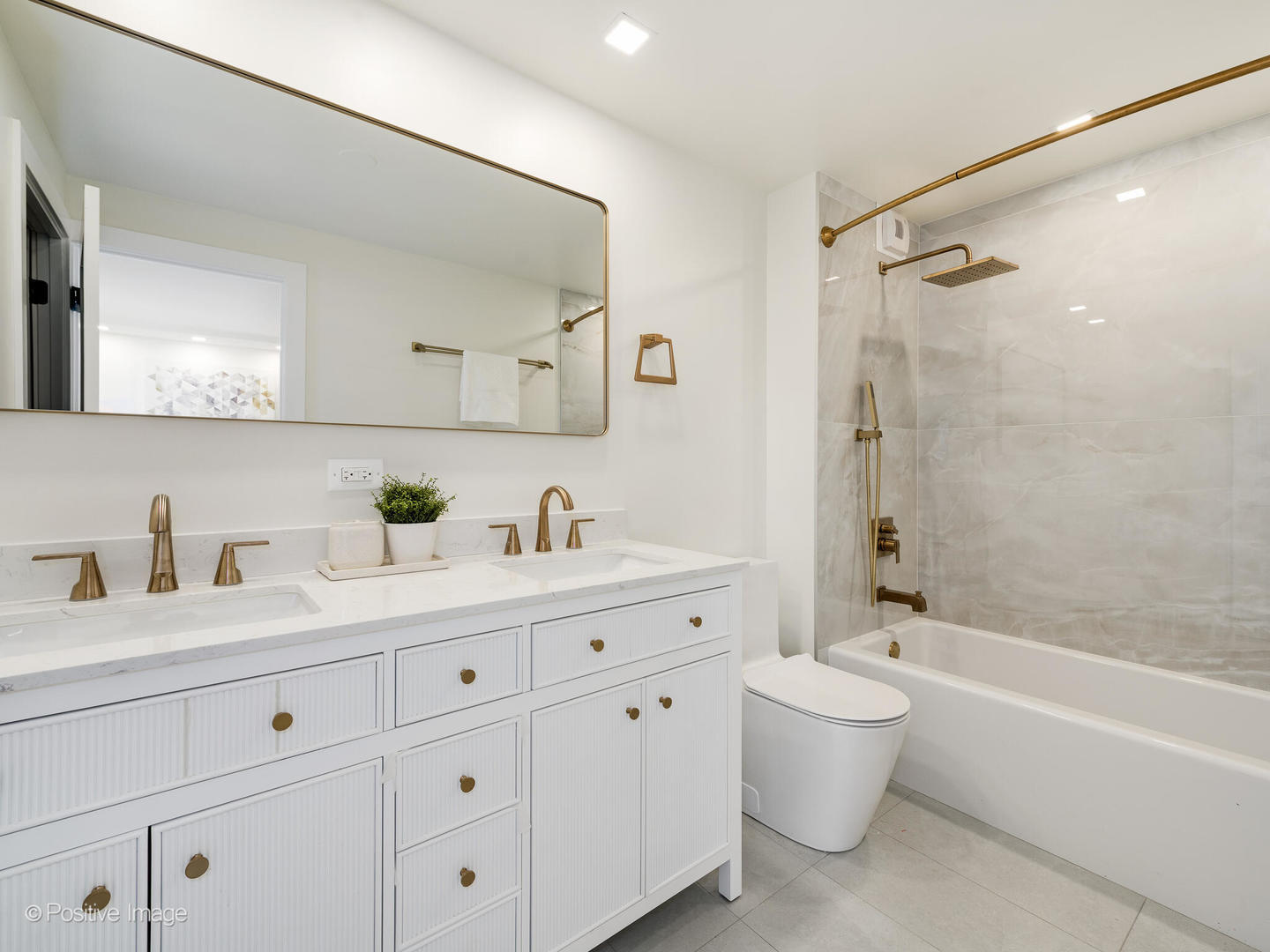 1310 North Ritchie Court, Unit 27B Chicago, IL 60610 - Photo 18 of 29 a bathroom with a granite countertop sink a toilet and a bathtub