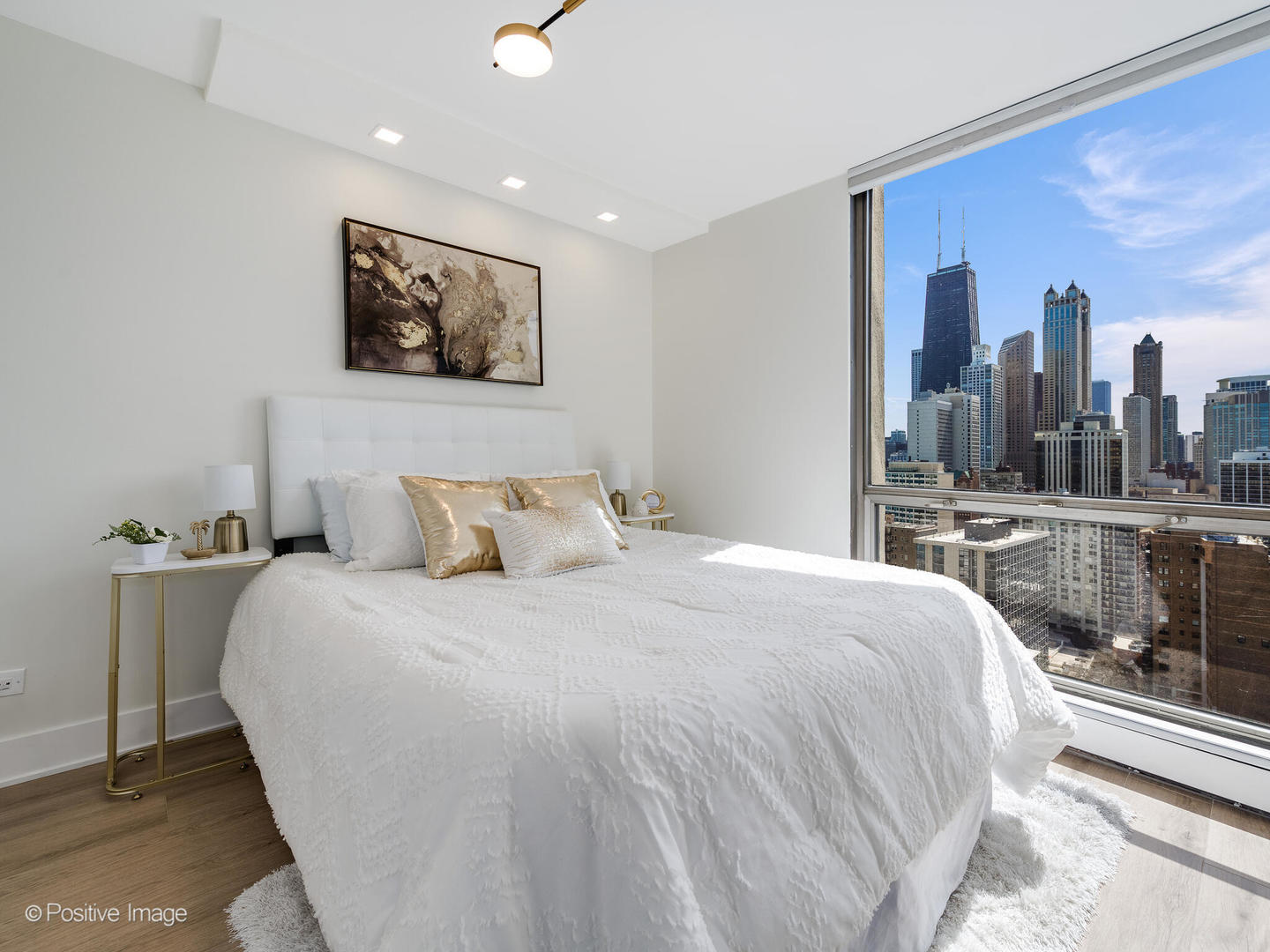 1310 North Ritchie Court, Unit 27B Chicago, IL 60610 - Photo 21 of 29 a bedroom with a large bed and a chandelier