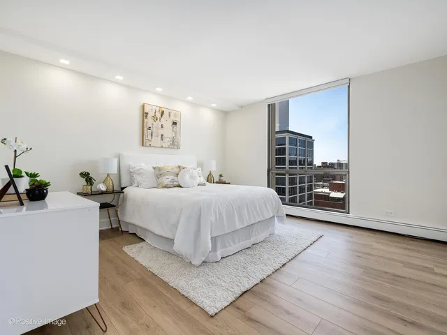a spacious bedroom with a bed and a desk