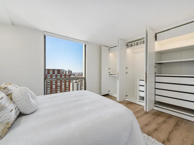 a bedroom with a bed and cabinet